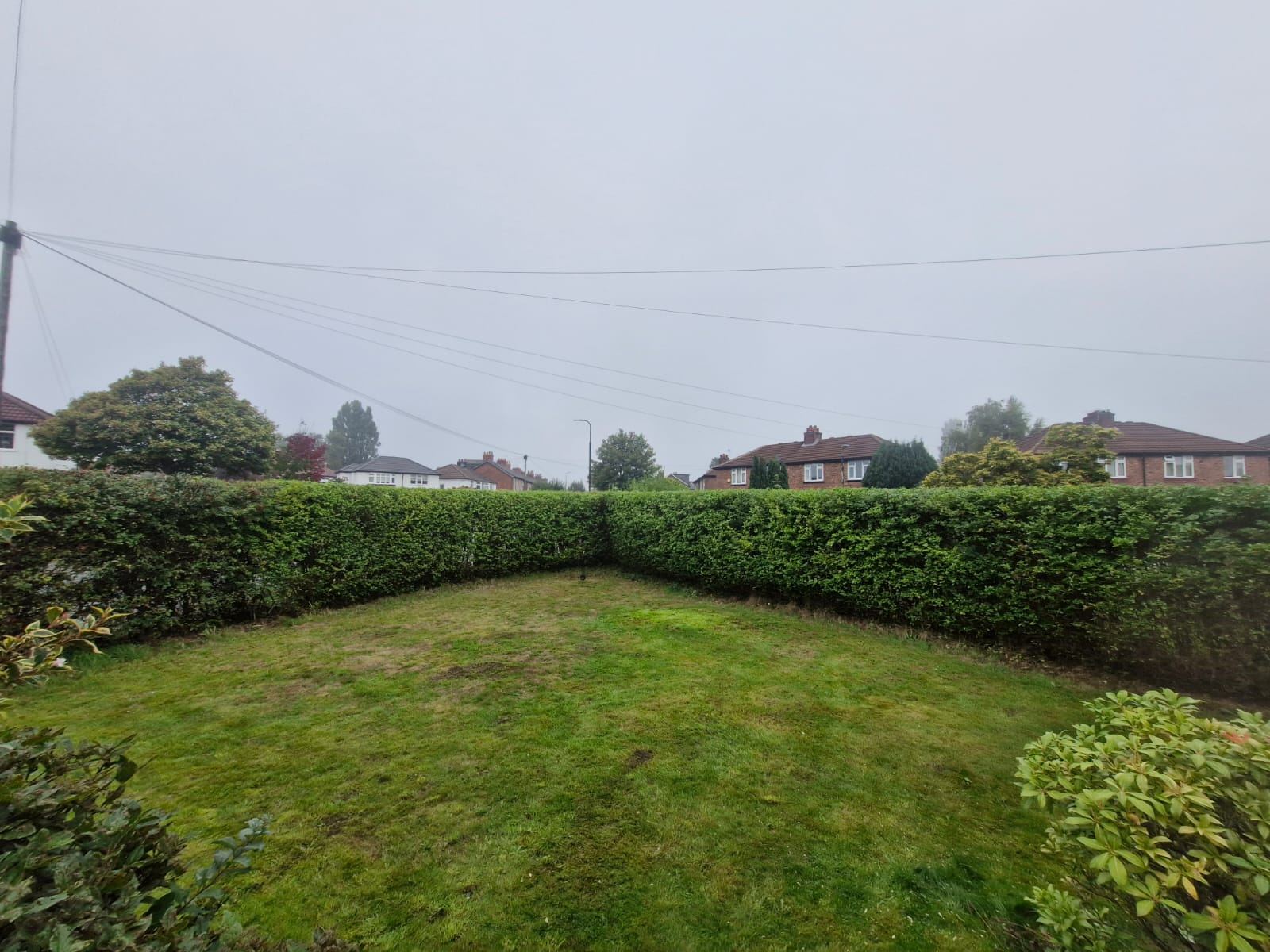 Low garden boundary hedges around a lawn cut level and square